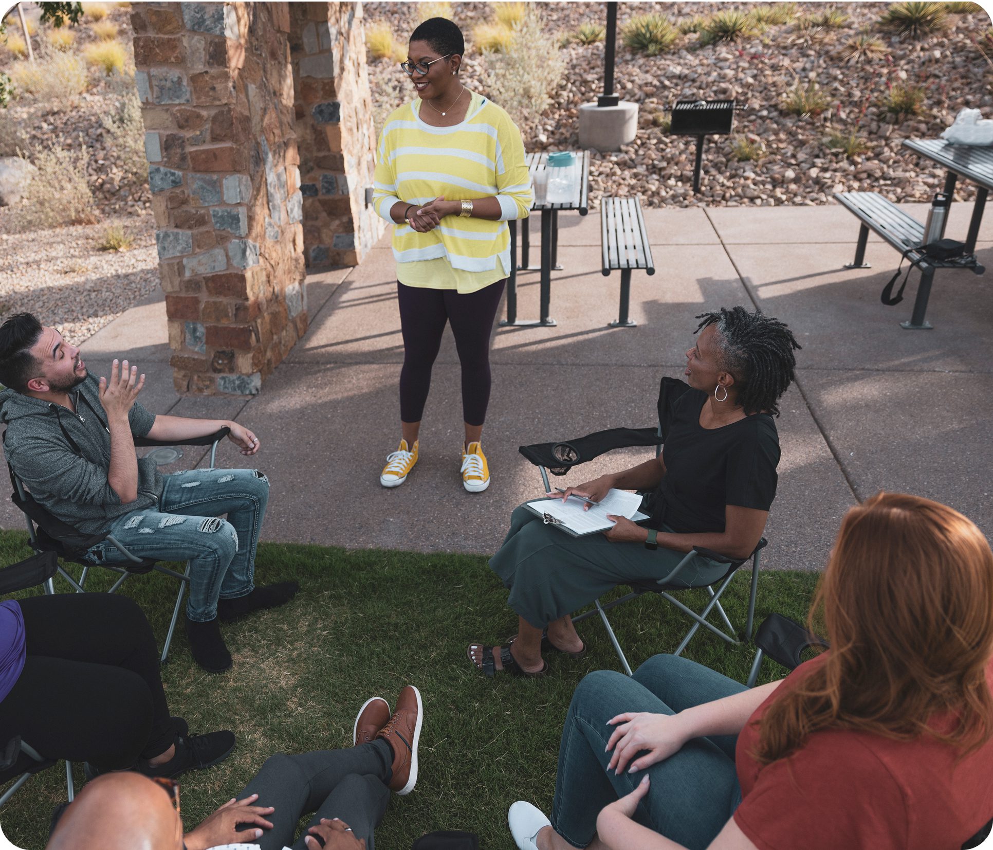 Woman leading discussion in outdoor setting