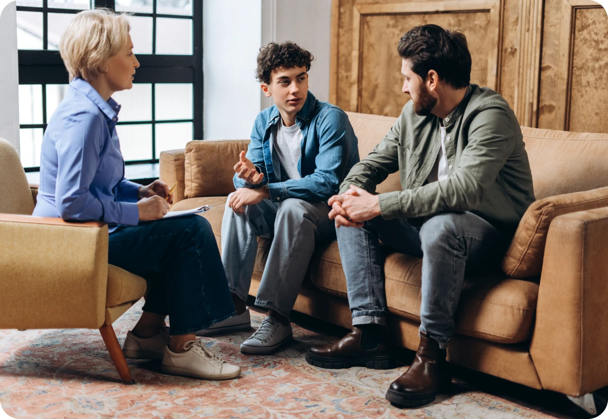 Therapy session with three people discussing